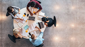 photo : Top view of group of bussines parsons sitting together at table.
